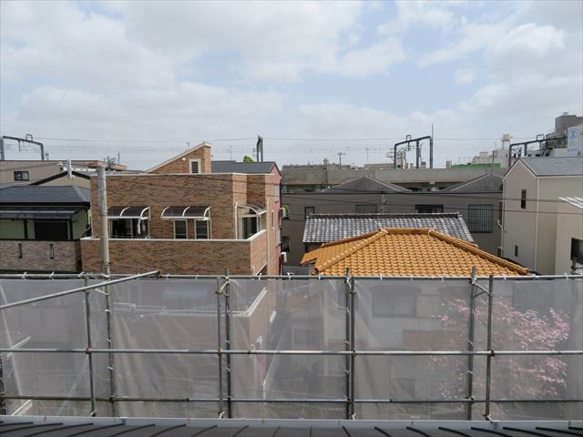 ガルバリウム鋼板でカバー工事が終わったマンションの屋根から東側を望む