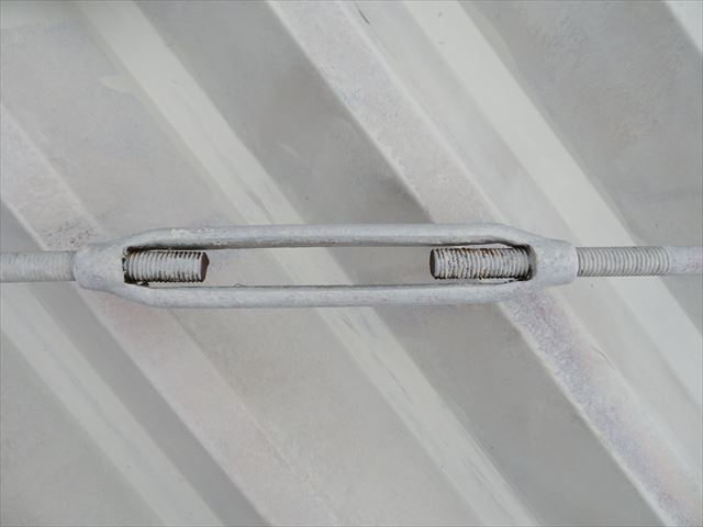 金属の丸い棒に引っ張り応力が働くように「ターンバックル」と言う部材で、引っ張っています。これを均等な力で引っ張ると、Ｈ型鋼が長方形を維持します。