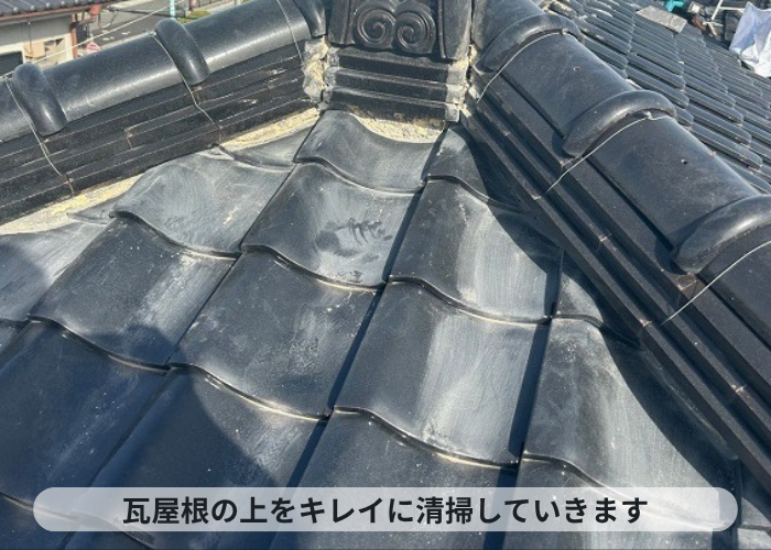 加西市　瓦屋根の漆喰修理で屋根上を清掃している様子