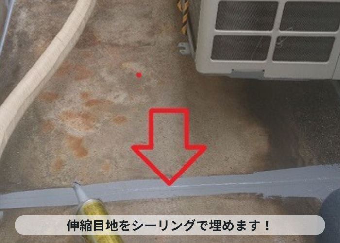 神戸市灘区　ベランダの防水工事で伸縮目地にシーリングを埋めている様子